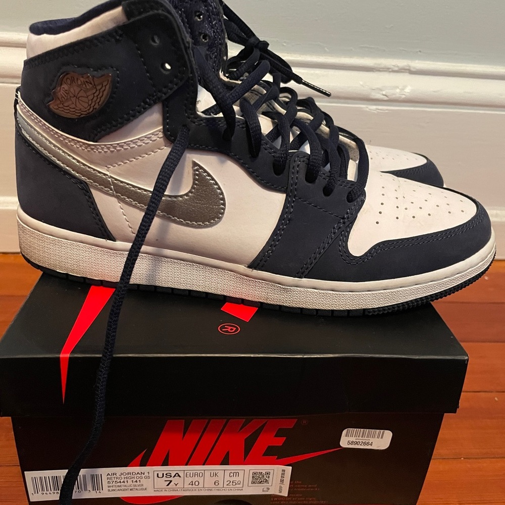 Blue suede Jordan 1, with silver swoosh.